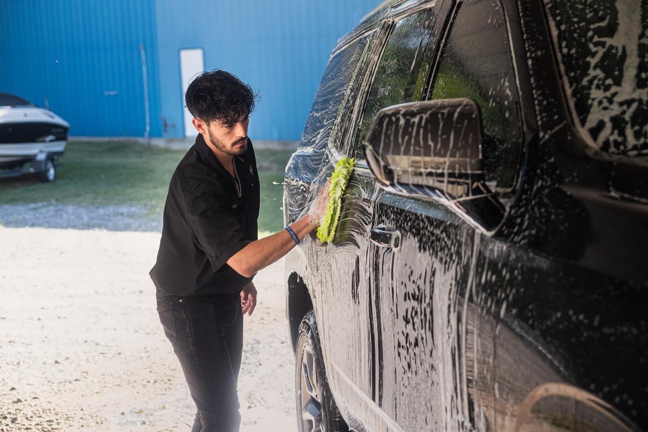 Washing black SUV with foam